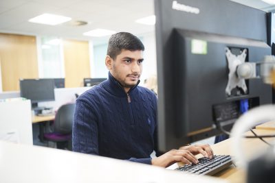 Male sitting a desk working on computer